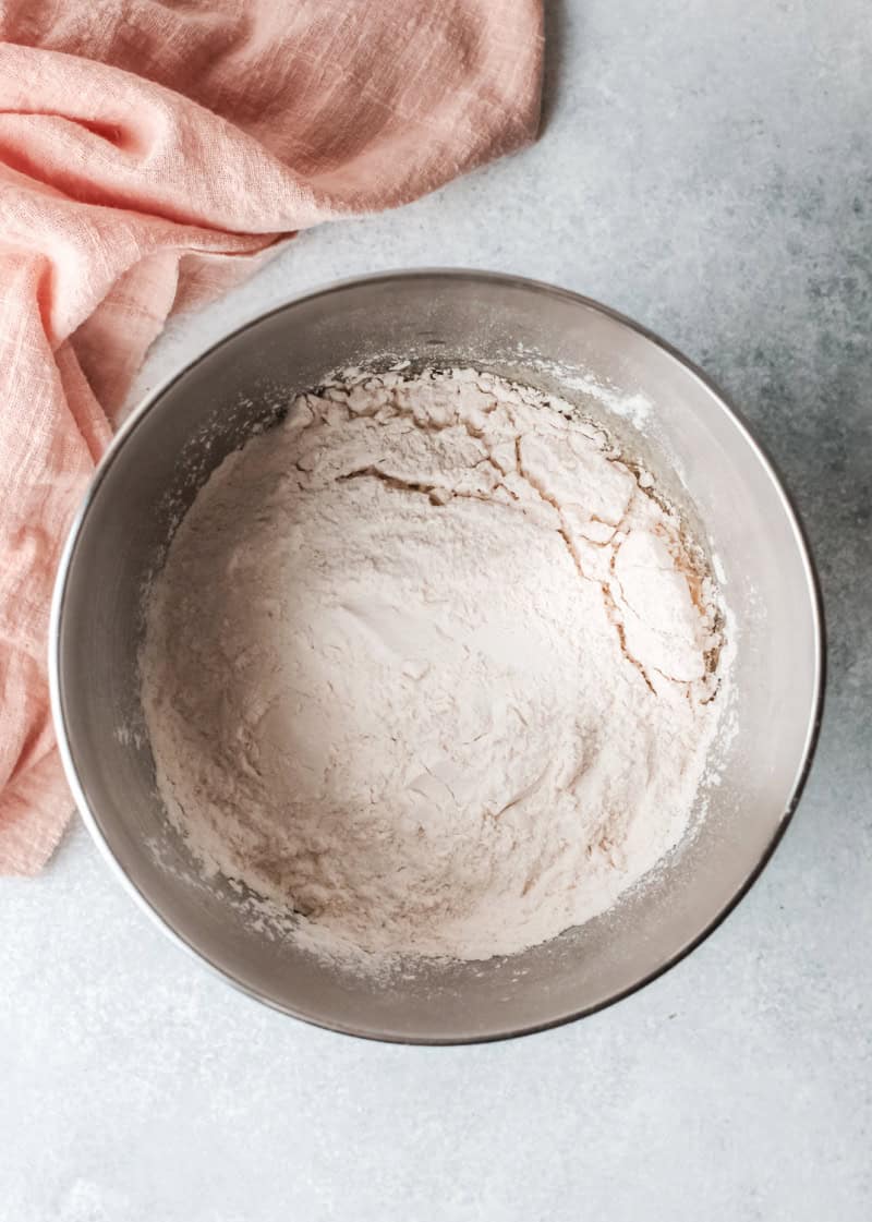 a flour mixture in a silver mixing bowl.