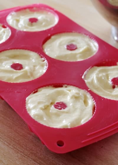uncooked batter in a small bundt cakes cooking tray.