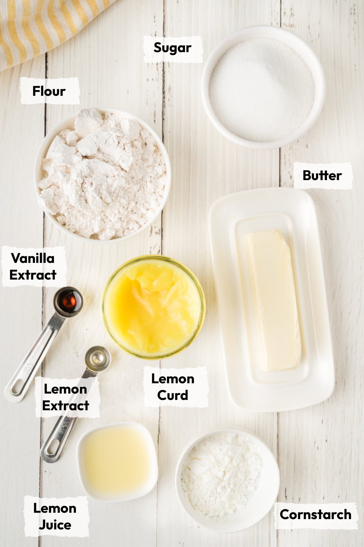 ingredients to make lemon thumbprint cookies like flour, lemon juice, sugar, extract and lemon curd.
