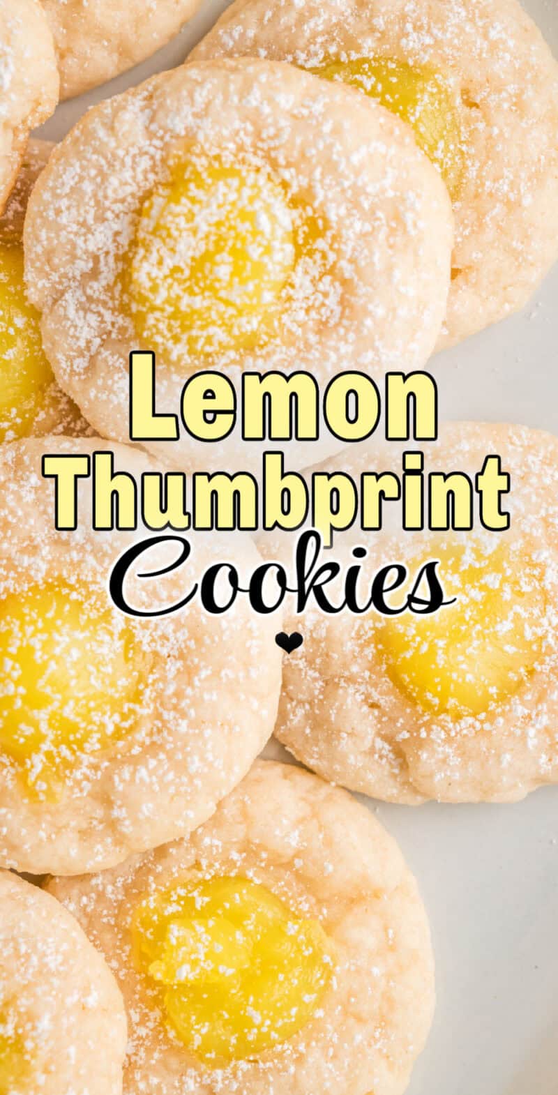 Lemon Thumbprint Cookies sprinkled with powdered sugar on a plate.