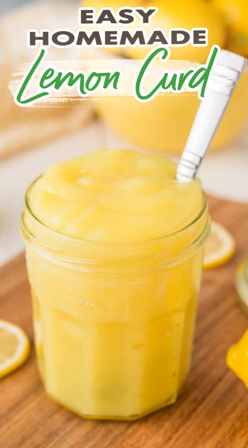 cooked bright yellow lemon curd in a jar with a spoon inside.