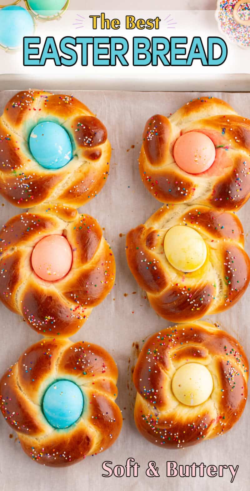 baked easter bread with colored sprinkles and a dyed egg in the middle.