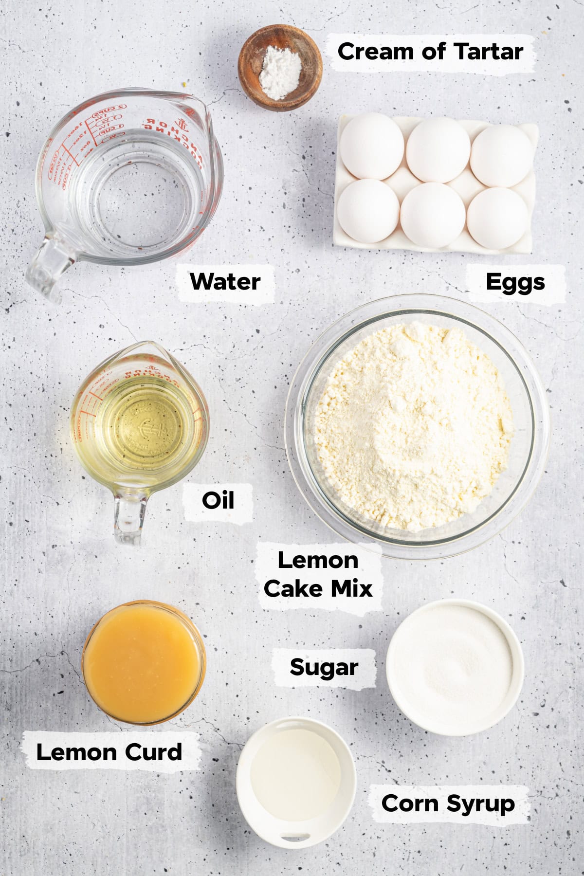 ingredients on a table such as eggs, cake mix, water, lemon curd, and corn syrup.