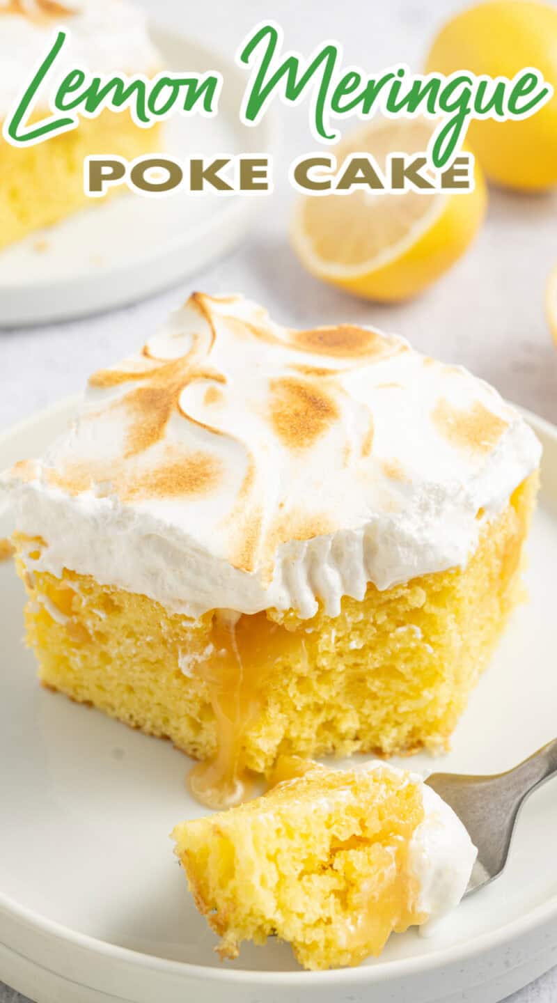 Lemon Poke Cake with toasted meringue on top, on a white plate, with some cake on a fork.