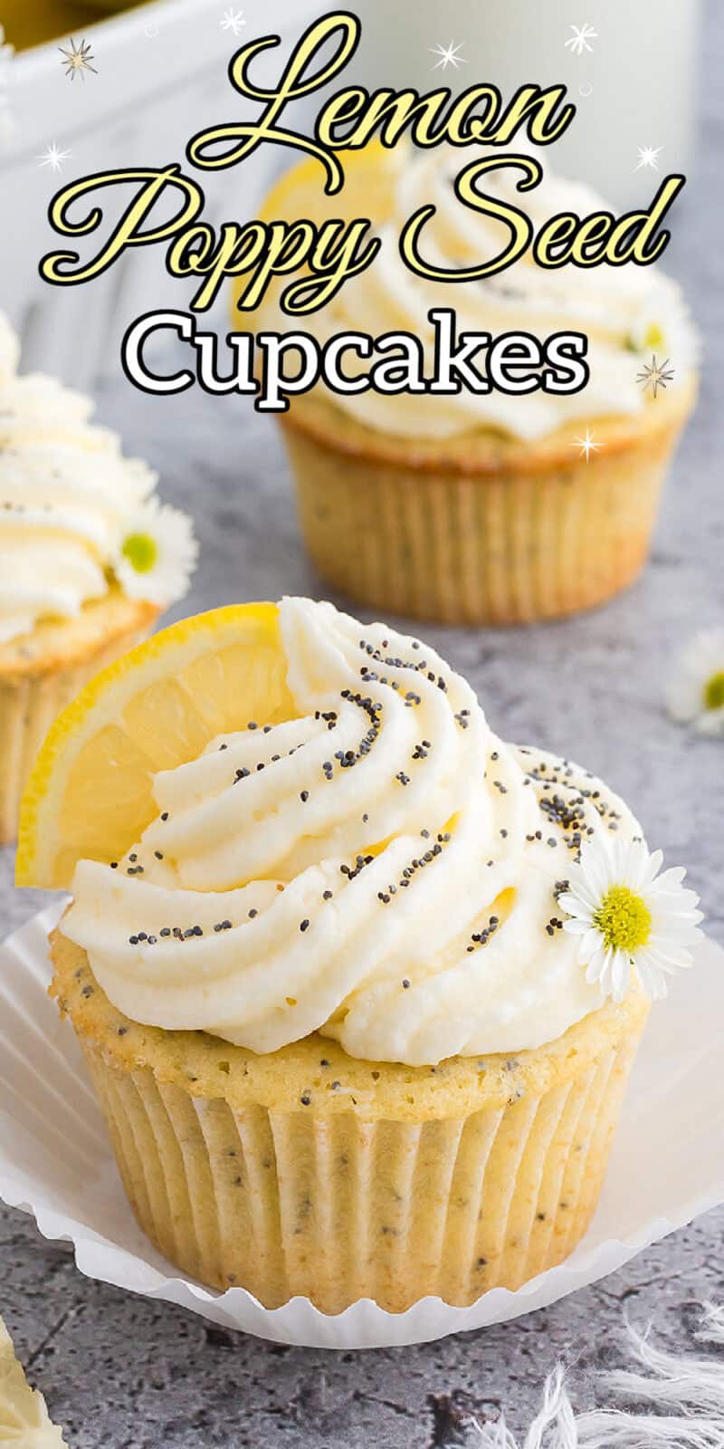 Lemon poppyseed cupcakes with a white buttercream icing on top, sprinkled with poppy seeds and a fresh lemon wedge on top.