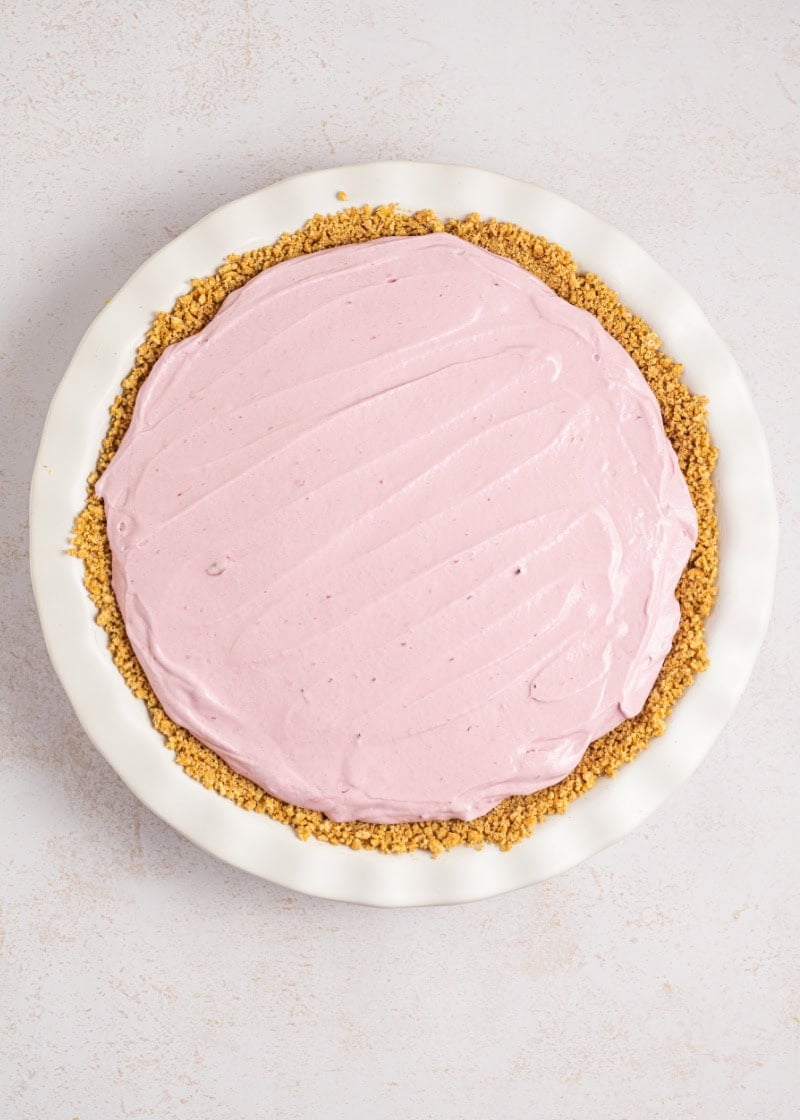 A whole Blackberry Cream Pie in a graham cracker crust in a pie plate.
