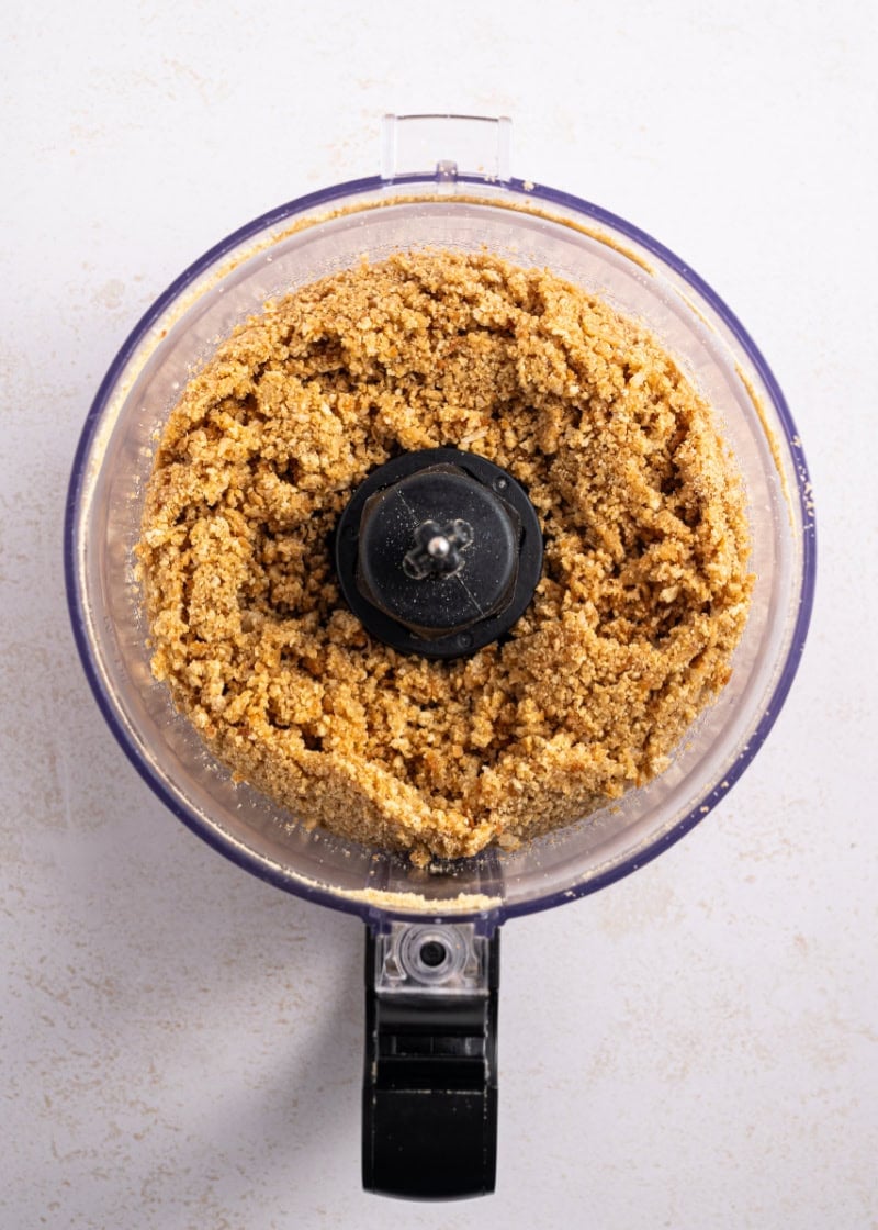 A food processor filled with graham cracker crumbs.