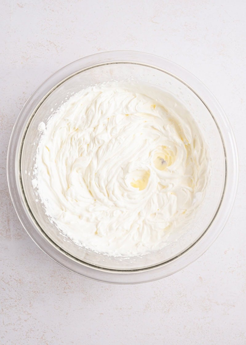 A glass bowl of homemade whipped topping.
