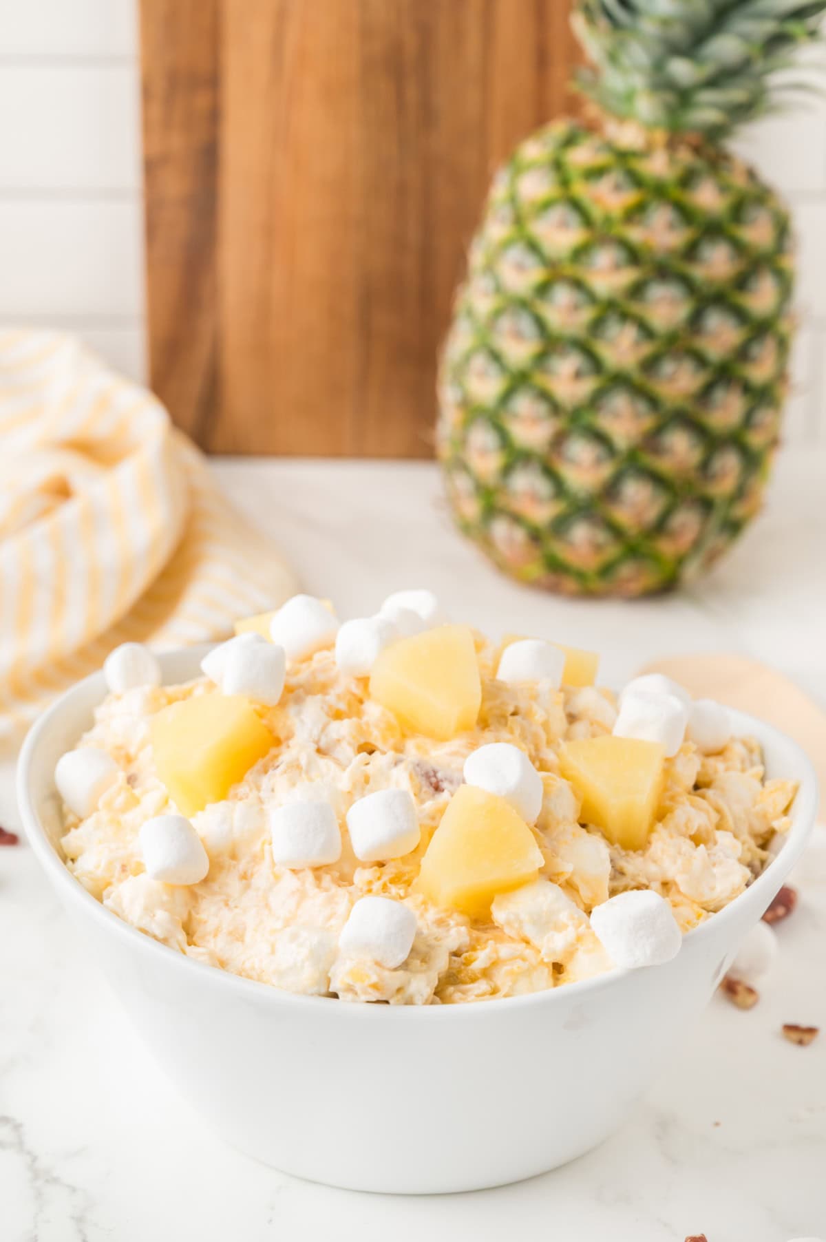Pineapple fluff dessert in a white bowl.