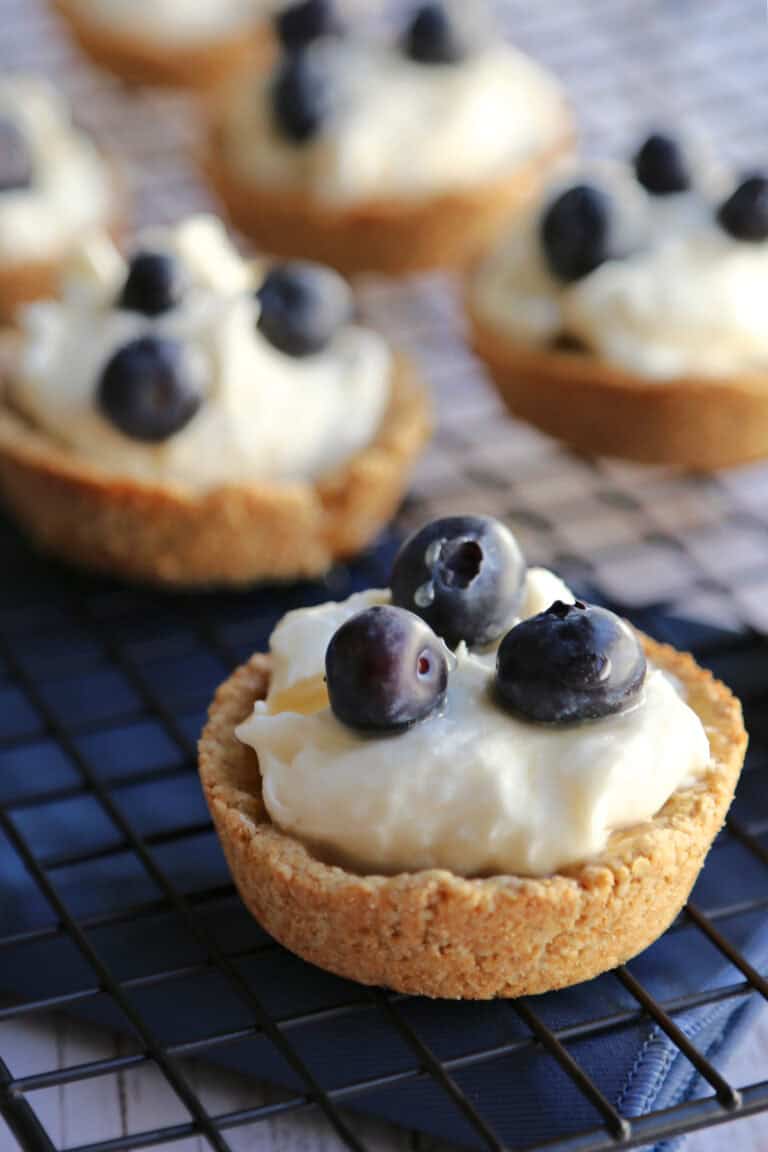 Blueberry cream cheese tarts on a cooling rack.