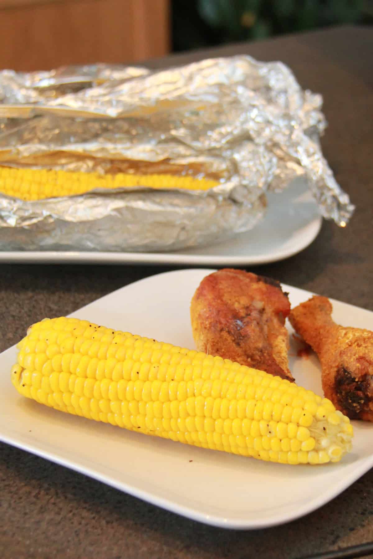 A plate with corn and chicken on it.