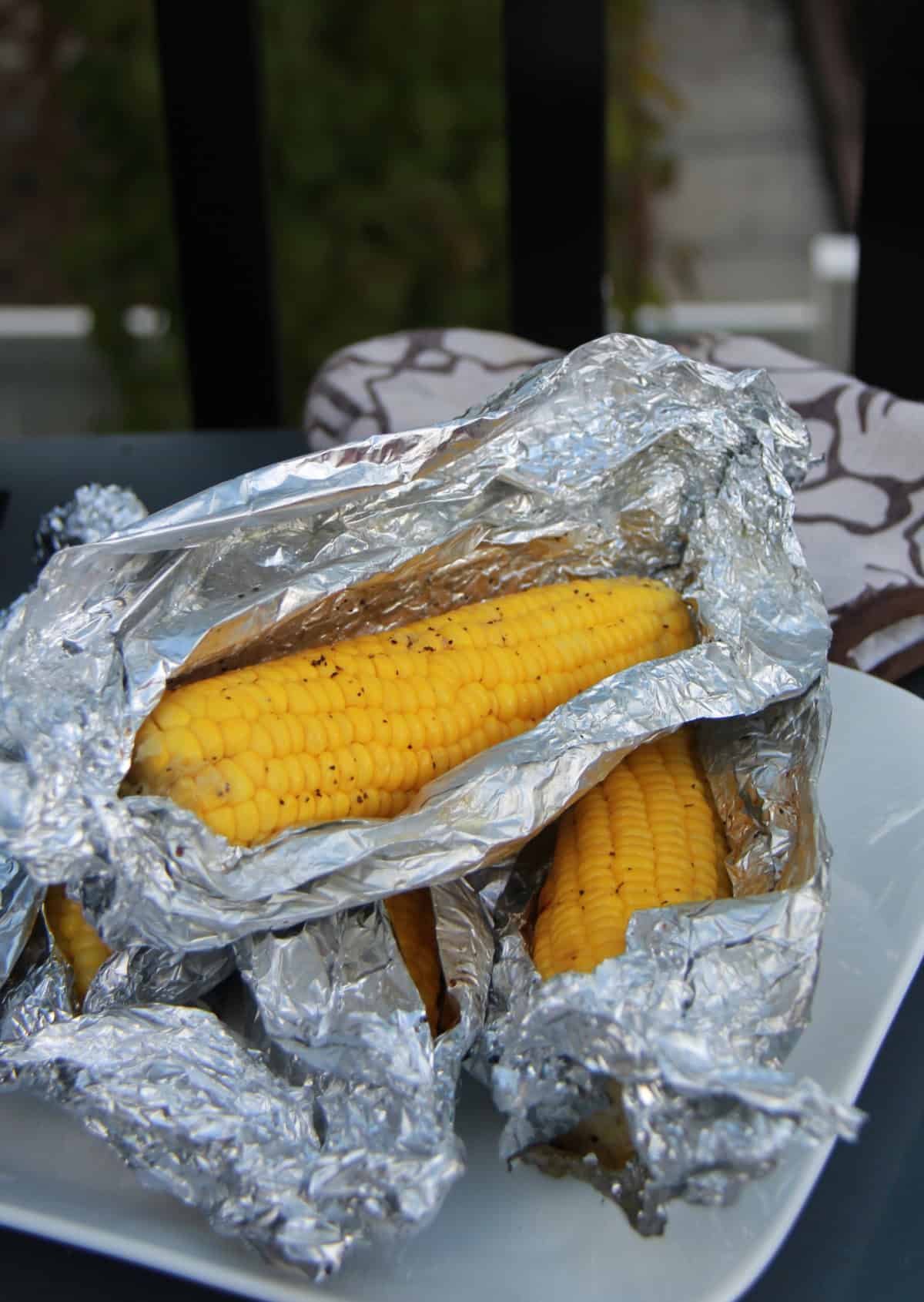 Corn on the cob wrapped in foil.
