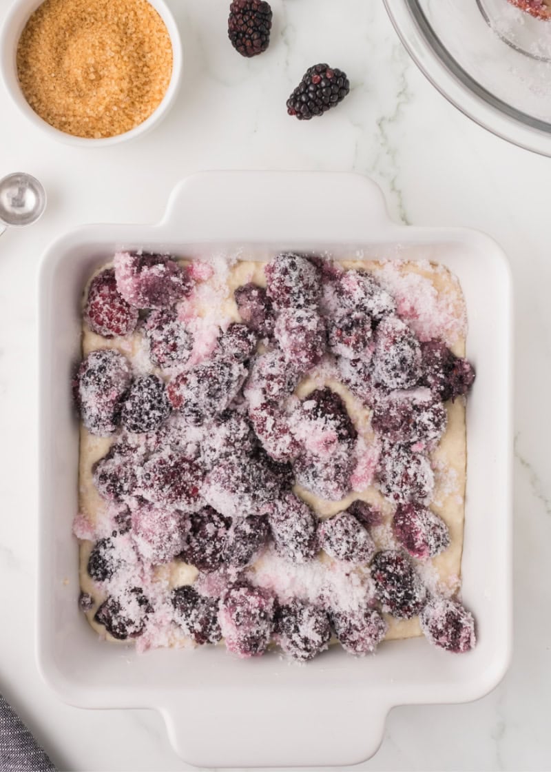 uncooked Blackberry cobbler in a white dish.