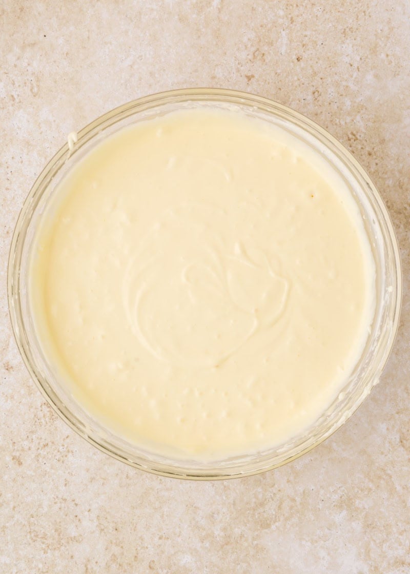 cheesecake batter in a glass mixing bowl.