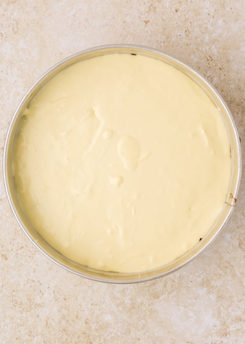 uncooked cheesecake batter in a springform pan.