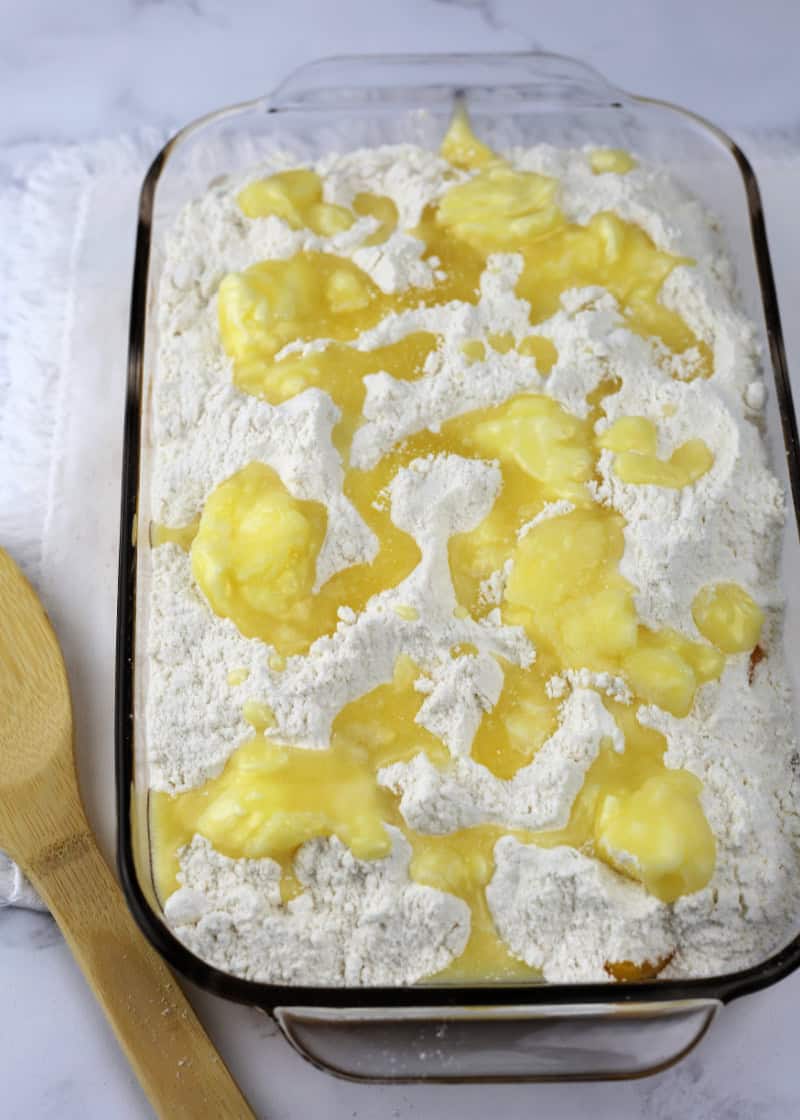 uncooked cake in a glass baking dish.
