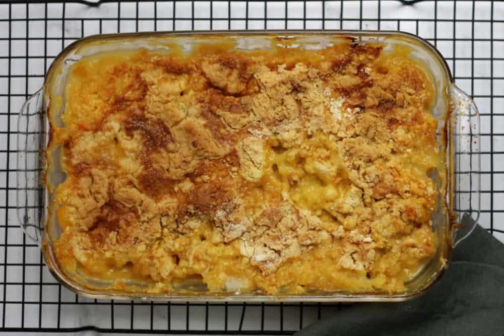 A casserole dish with peach dump cake in it.