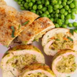Stuffed chicken breast stuffed with stuffing and served with peas.
