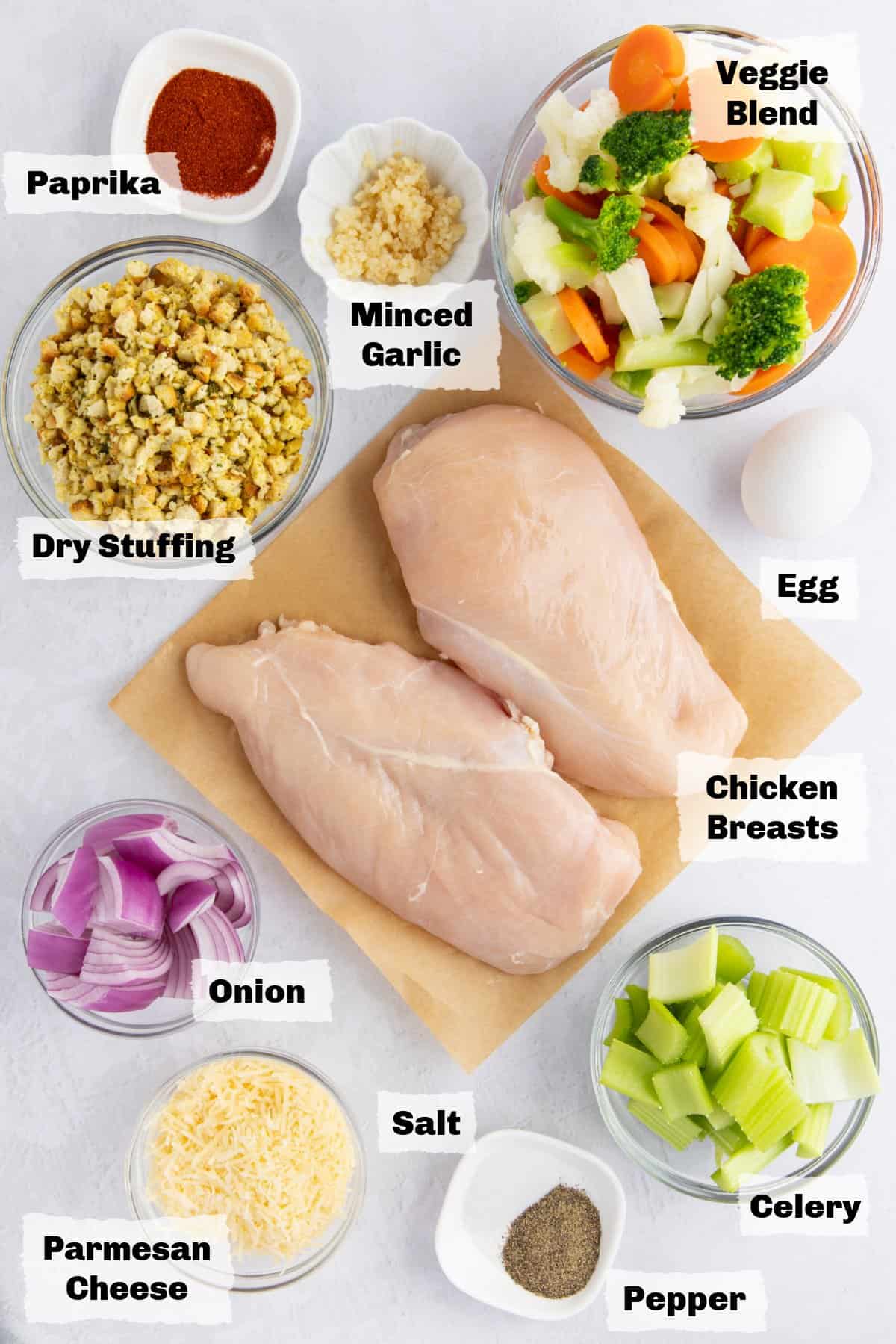 Ingredients on a table to make stuffing stuffed chicken breast.