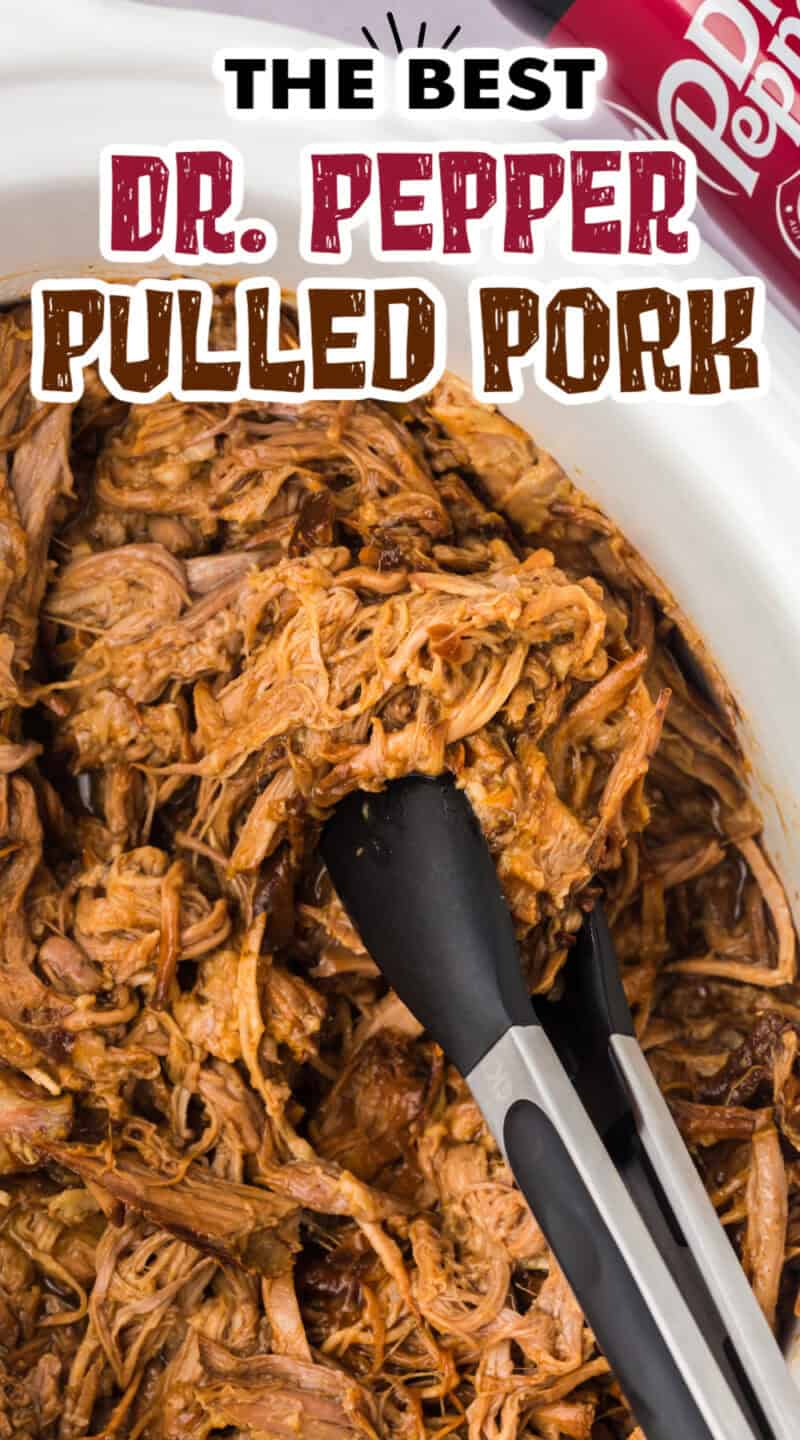 Slow cooker pulled pork in a crockpot with tongs.
