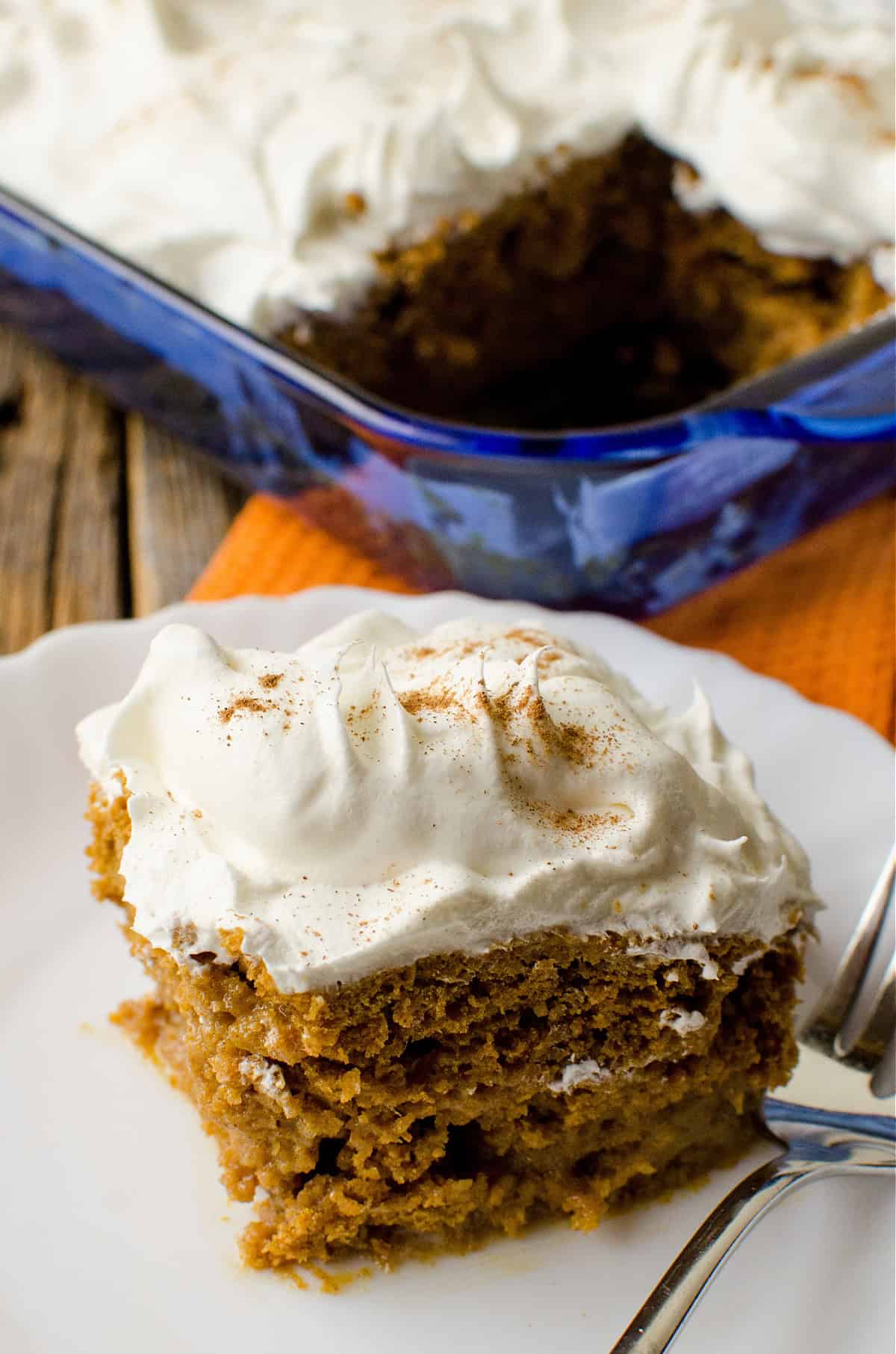 Pumpkin Spice Poke Cake spice on a white plate.