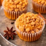 Pumpkin Streusel Muffins on a plate with cinnamon sticks and star anise.