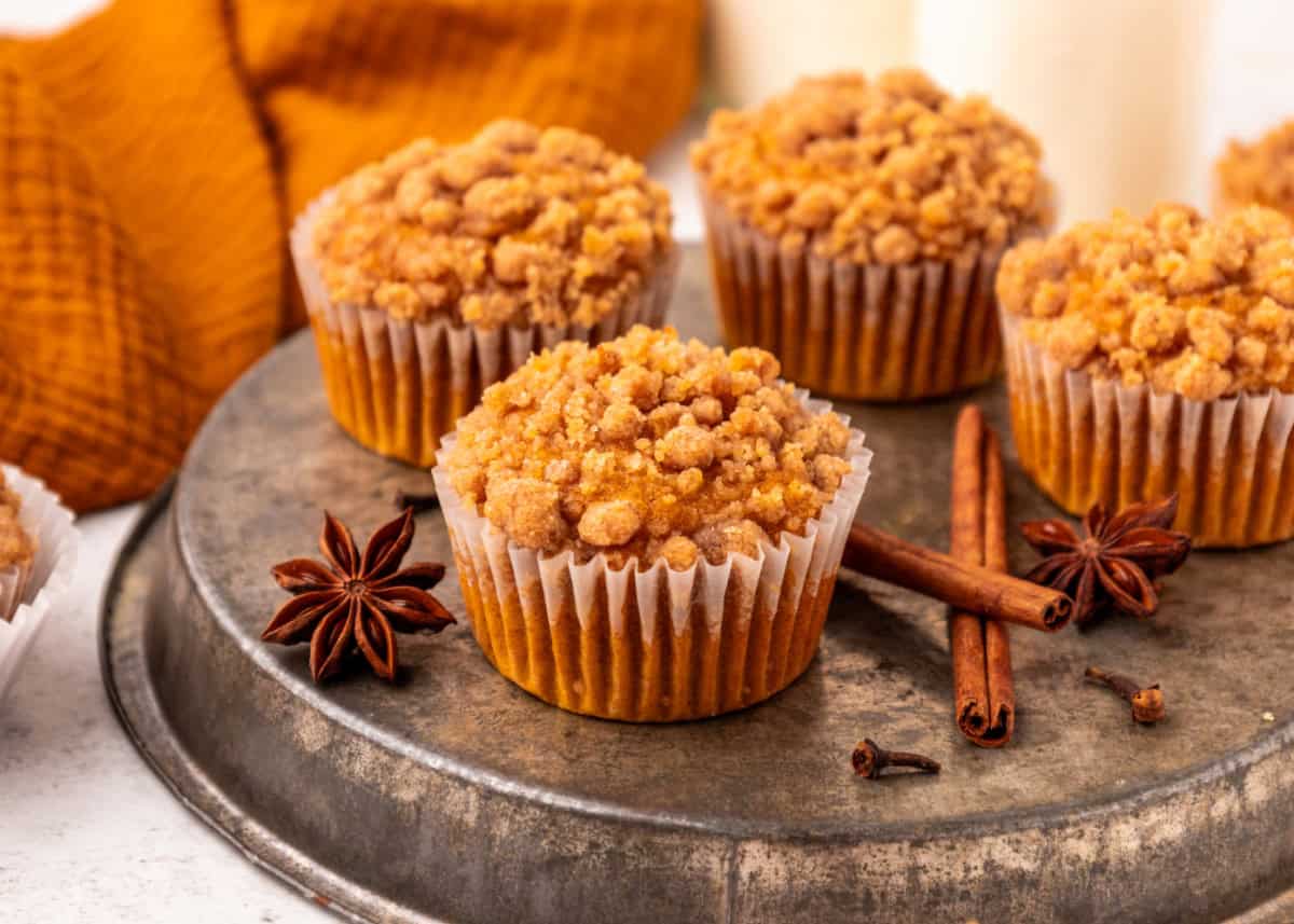 Pumpkin Streusel Muffins on a plate with cinnamon sticks and star anise.