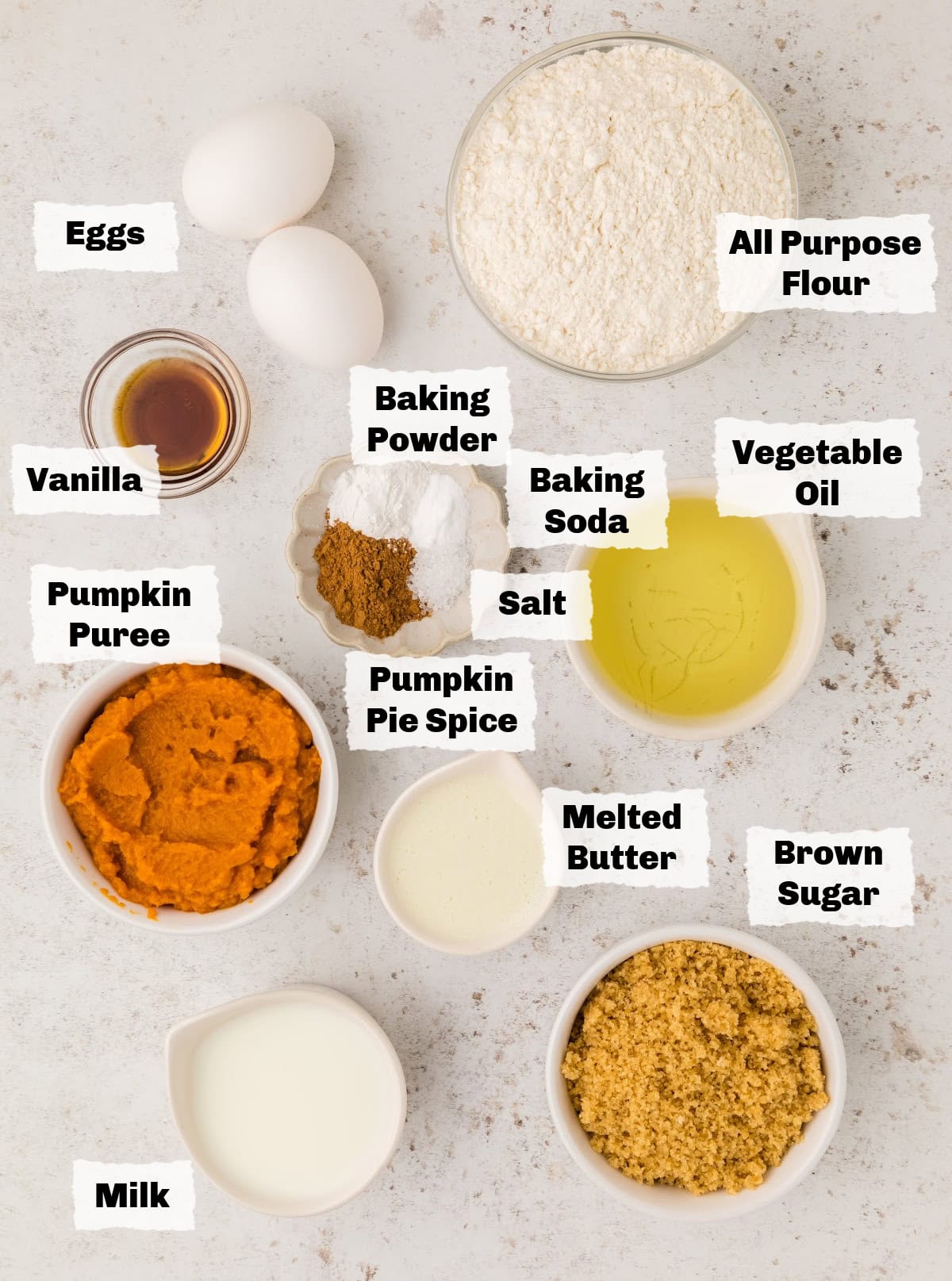 Ingredients on a table to make Pumpkin Streusel Muffins.