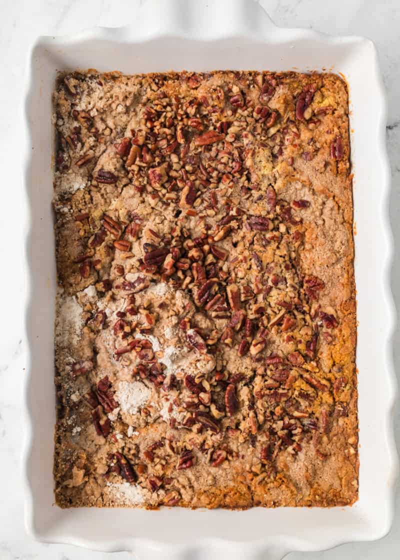 Overhead photo of a whole pumpkin dump cake in a white baking dish.