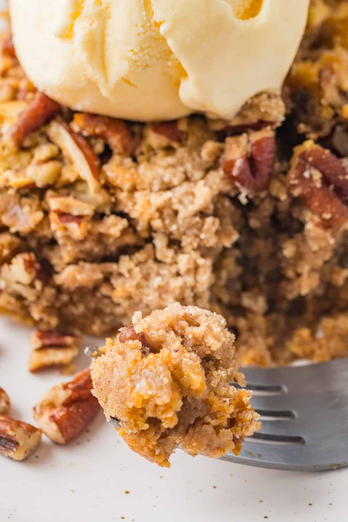 Homemade pumpkin dump cake with a closeup of some on a fork.
