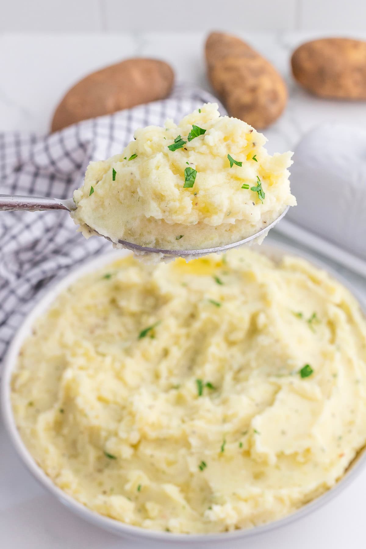 a spoonful of Boursin mashed potatoes being taken from a bowlful.