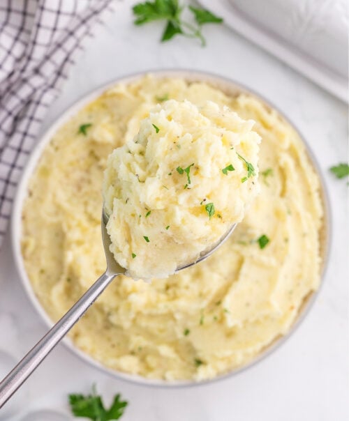 Boursin mashed potatoes in a bowl and on a spoon.