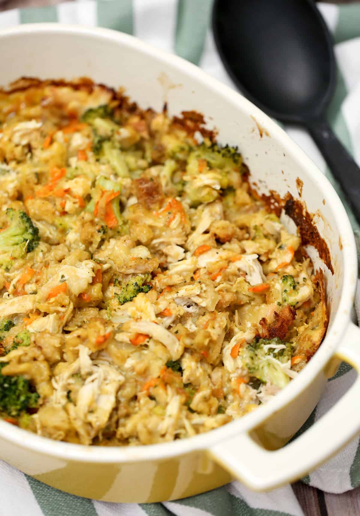 Chicken and Stuffing Bake in a casserole dish with a serving spoon beside it.