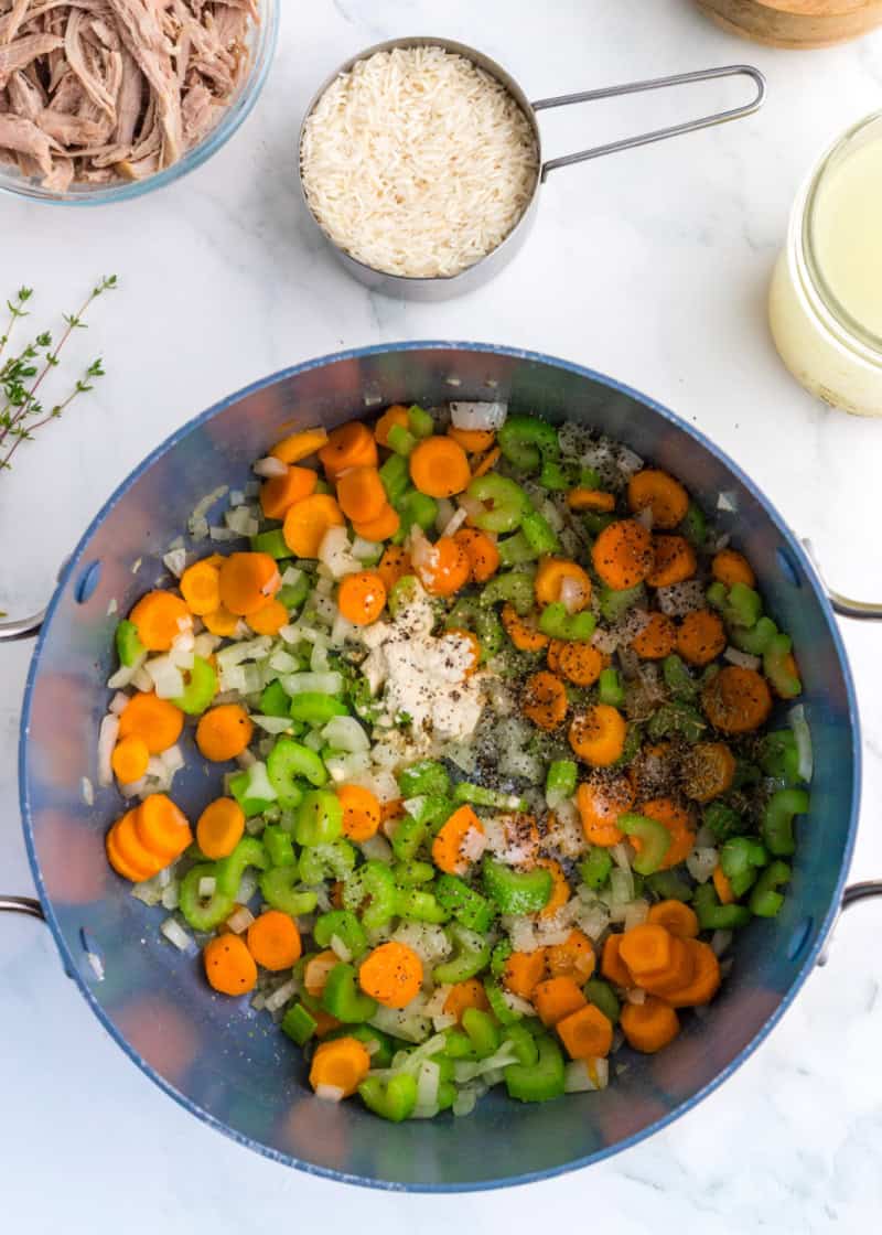 chopped carrots and celery in a soup pot.