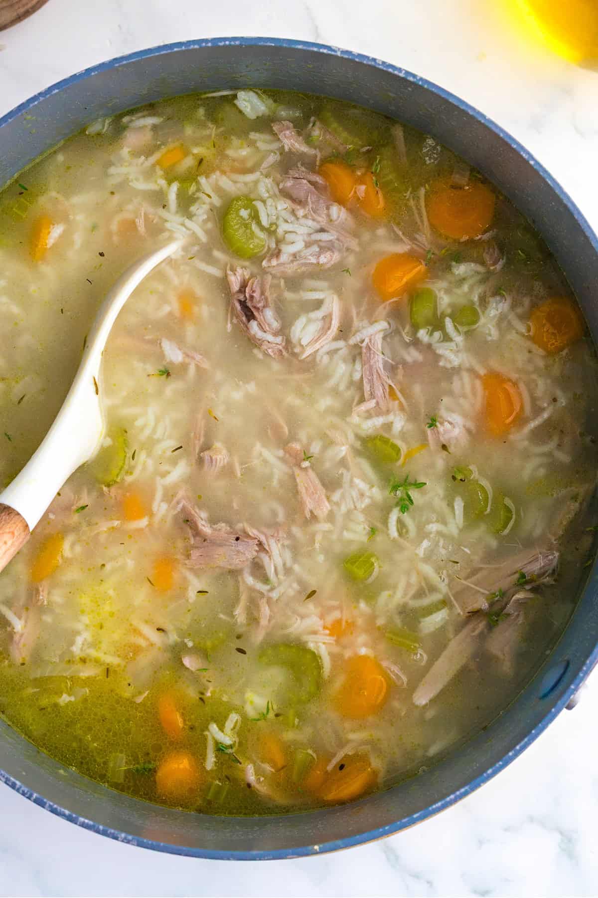 Turkey and Rice Soup in a pot with a ladle.