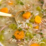 Turkey and Rice Soup in a white bowl with a spoon.