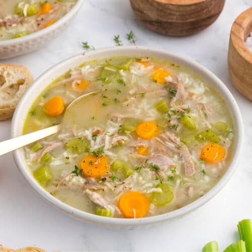 A bowl of Turkey and Rice Soup with a spoon.
