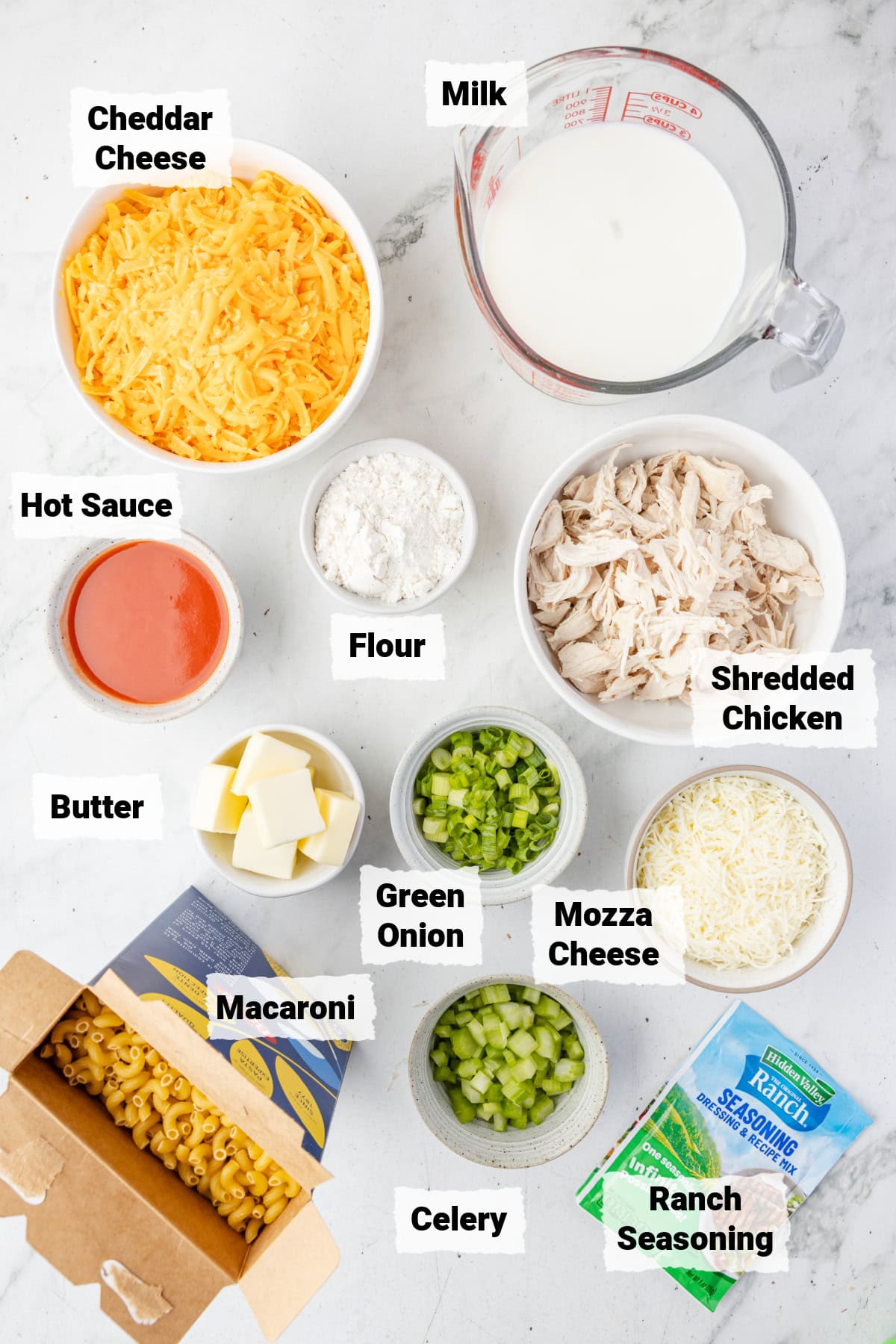 ingredients on a table to make buffalo chicken mac and cheese.