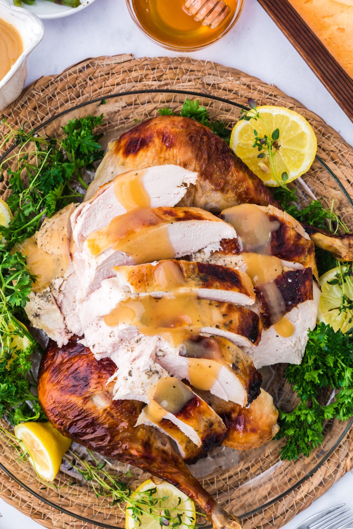 sliced honey glad turkey with turkey gravy on top.