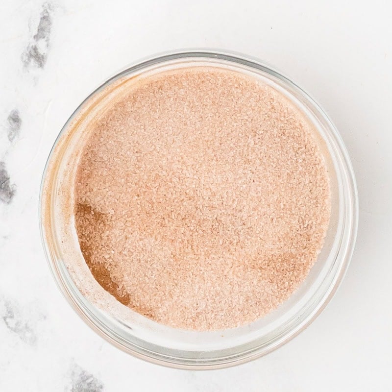 cinnamon and granulated sugar mixed together in a small glass bowl.