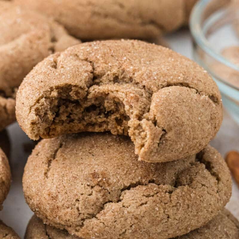 Spice Cake Mix Cookies in a pile with a bite taken out of the top one.