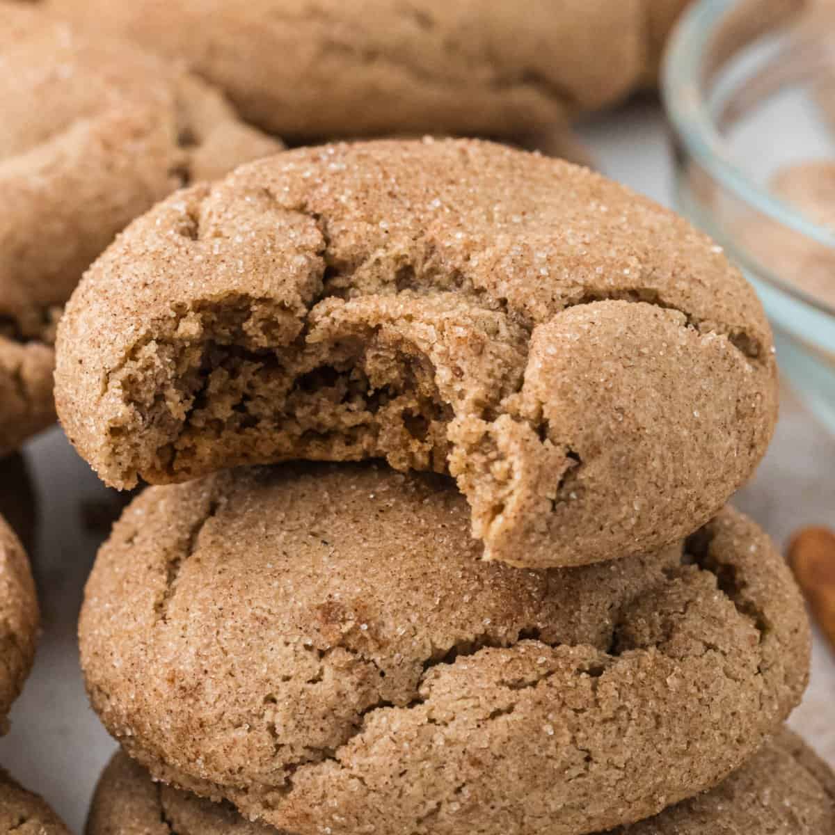Spice Cake Mix Cookies in a pile with a bite taken out of the top one.