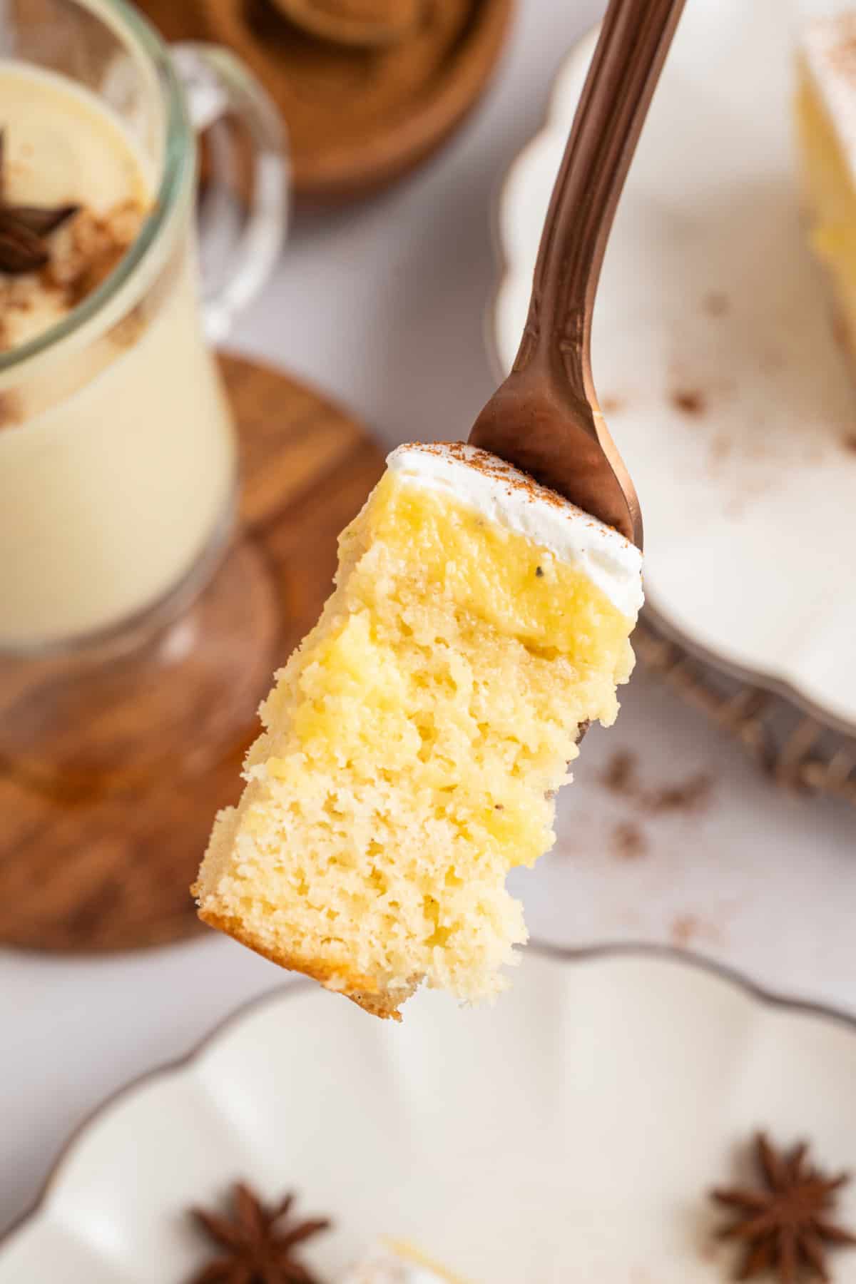 a piece of eggnog poke cake on a fork.