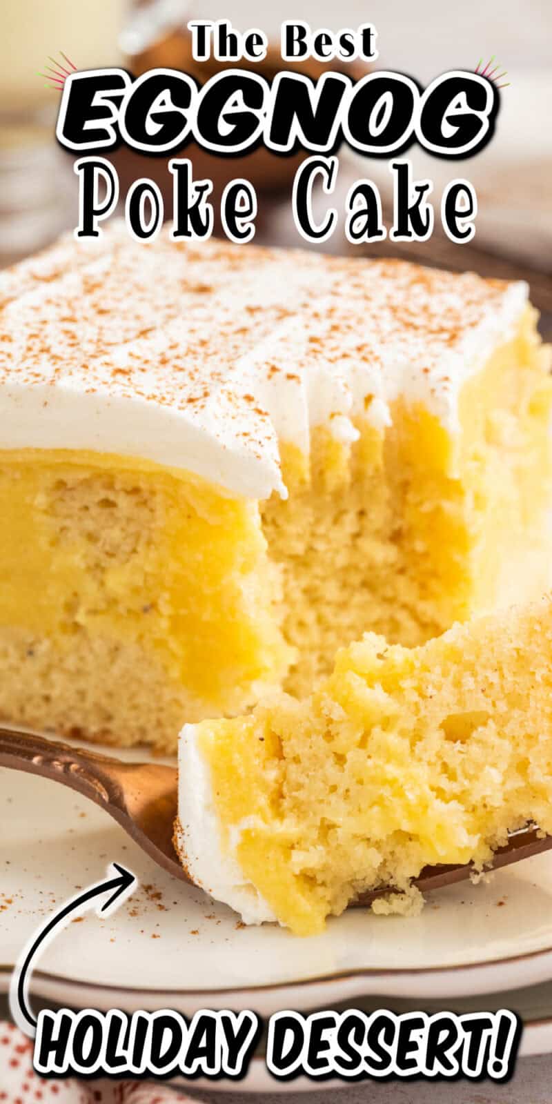 a slice of eggnog poke cake with whipped topping and cinnamon on top.