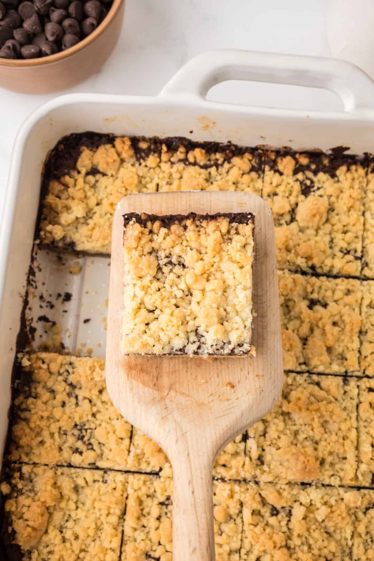 Sliced Chocolate Shortbread Bars and one being lifted out of the pan.