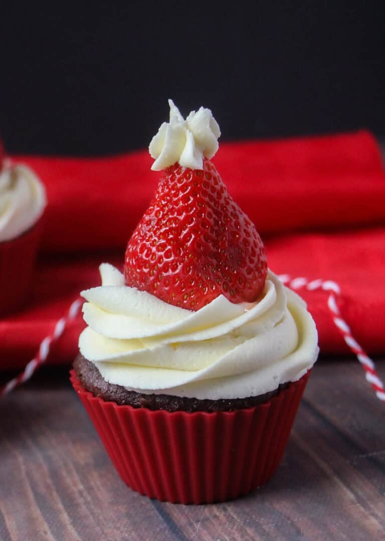 One santa hat cupcake on a table.