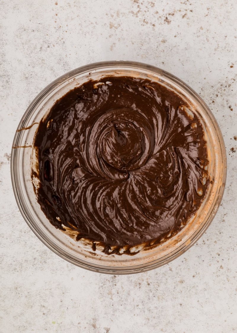 snickers brownies batter in a glass bowl.