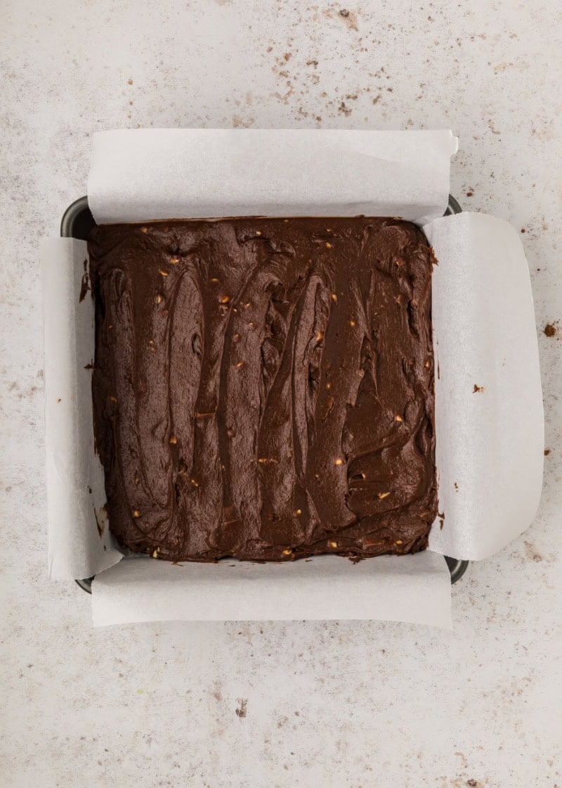unbaked snickers brownies in a baking pan.