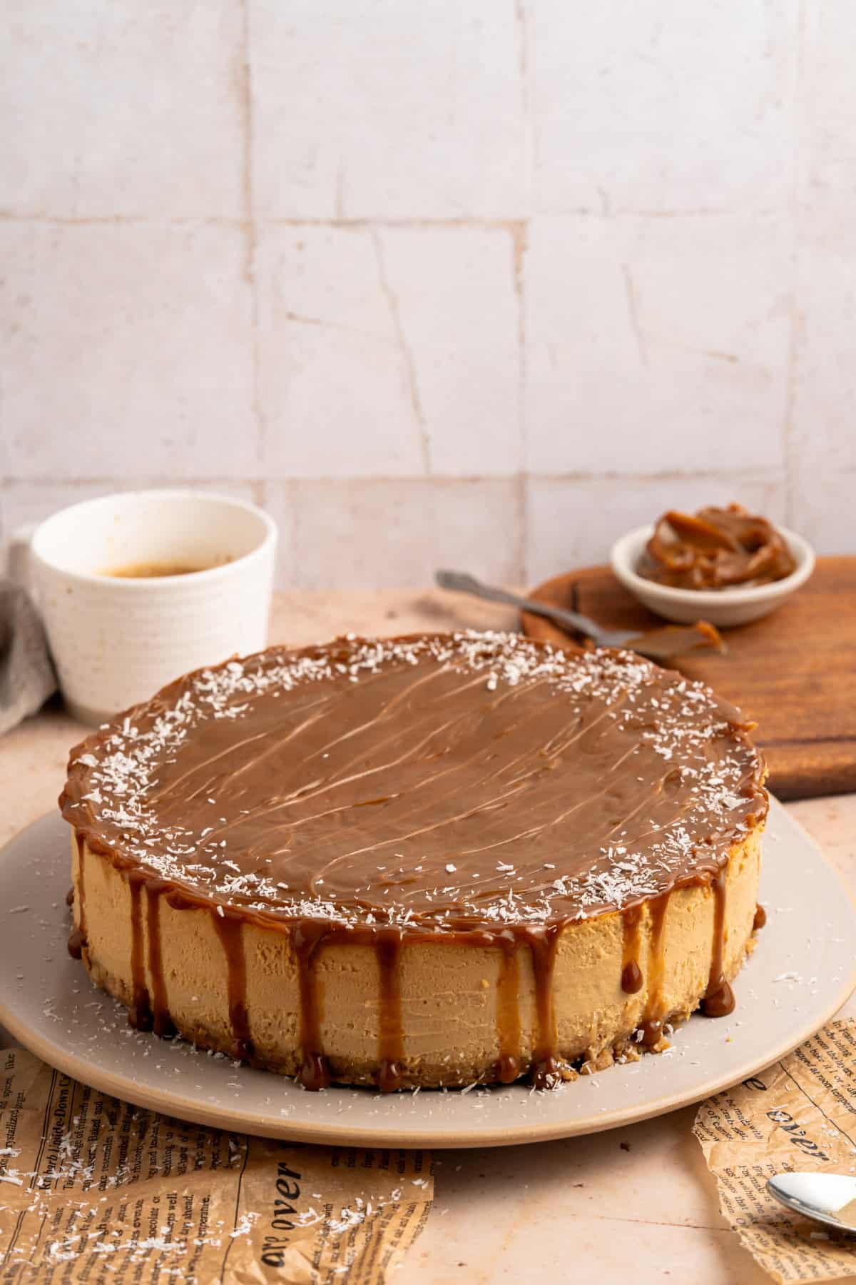 A whole Dulce de Leche Cheesecake on a table.
