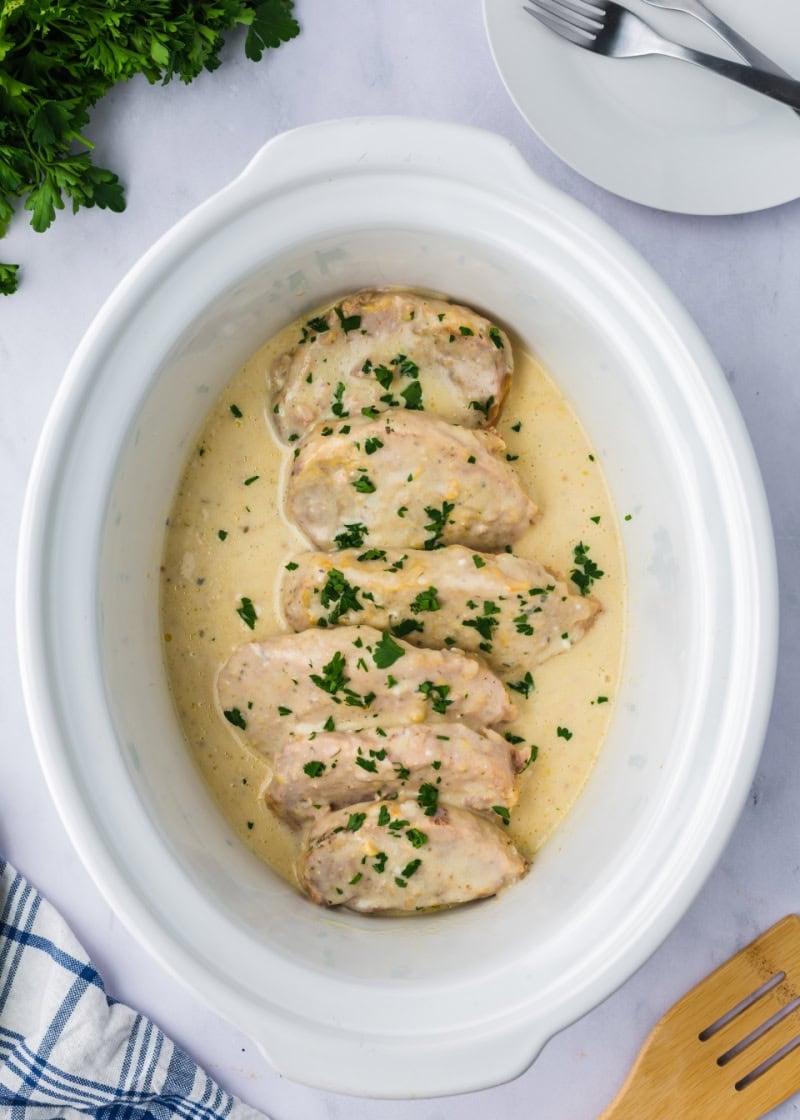 pork chops in a creamy ranch sauce cooked in a slow cooker.